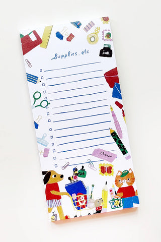 A white notepad with blue lined writing space and colorful illustrated stationery and cartoon animals around the border