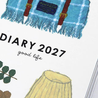 2027 diary title text with blue blanket illustration on planner cover close-up