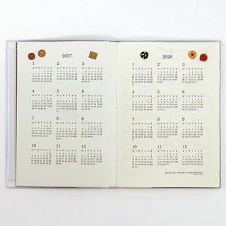 Open 2027–2028 calendar spread with month grids and small icon accents