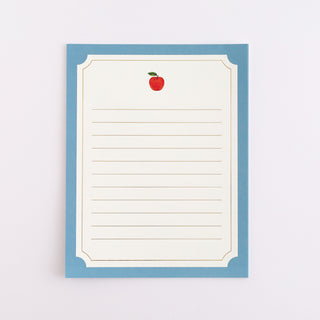 Paper with a red apple illustration on a light blue border