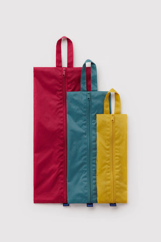 BAGGU 3D zip set: three handled pouches in red, teal, and yellow