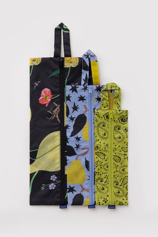 3D zip pouch set standing side by side with black floral, star print, and olive paisley styles