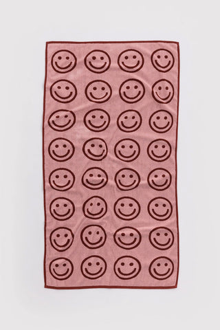 Blush bath towel with repeating smiley faces printed in dark outline