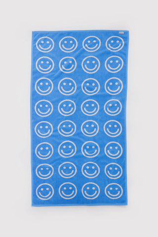 Sky blue bath towel with repeated outlined smiley faces