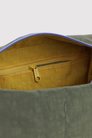 Close-up of BAGGU dopp kit interior with yellow lining and blue-edged zipper