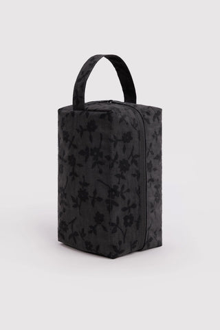 Charcoal floral toiletry bag with tote handle, textured fabric, zip-top closure
