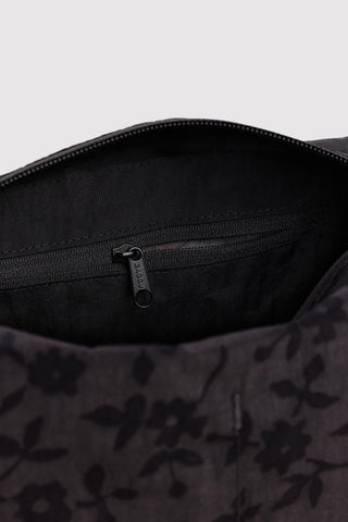 Open interior of charcoal floral toiletry bag with zipper and black lining