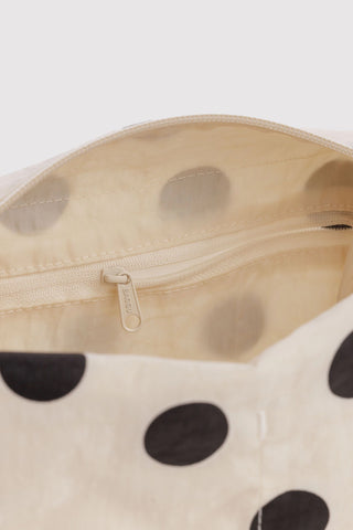 Cream polka dot dopp kit close-up of zipper and inner fabric lining