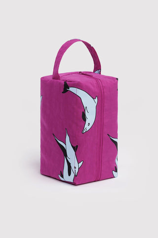 Pink pouch with dolphin designs on a light gray background