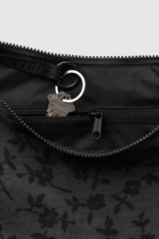 Charcoal nylon bag zipper with small floral lining and metal keyring pull
