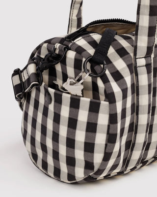 Black-and-cream gingham duffle bag with side zipper pocket and adjustable strap