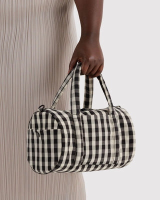 Black-and-cream gingham duffle bag with wide top handle and zipped top
