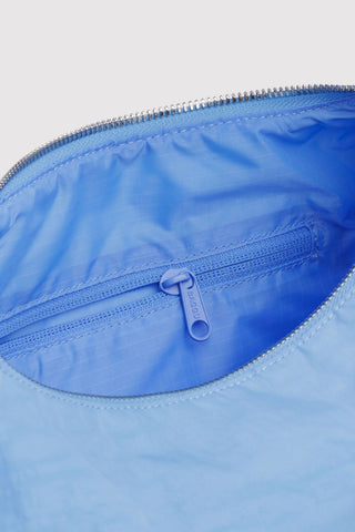 Close-up of a blue bag with a zipper on a light gray background