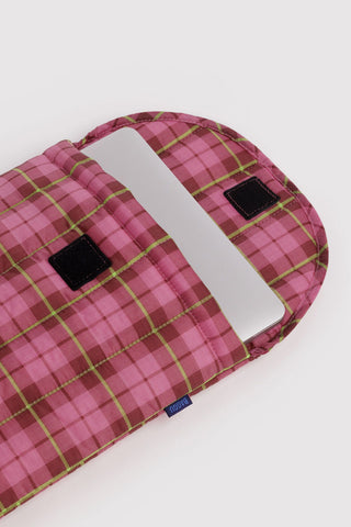 Open puffy laptop sleeve showing pink tartan plaid interior and black label patch