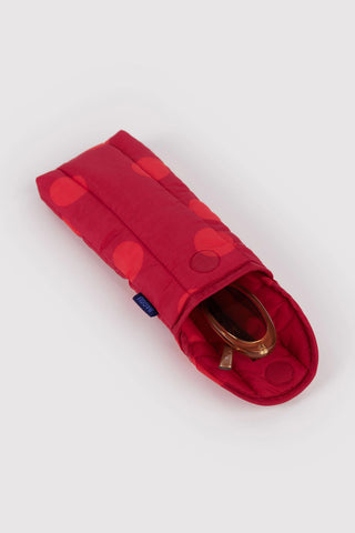Red polka dot puffy glasses sleeve, angled view with eyeglasses inside