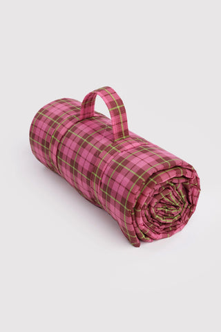 Puffy picnic blanket in pink and green tartan, rolled with carry handle