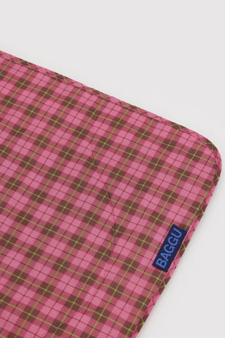 Puffy picnic blanket corner with pink and green tartan and BAGGU label