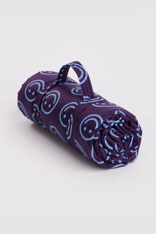 Indigo patterned puffy picnic blanket, rolled with carrying handle