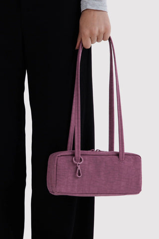 Plum nylon bowler bag with two top handles and front zipper detail