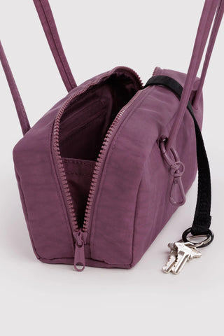 Plum nylon bowler bag with open top zipper and key clip at side