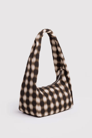 Plaid patterned handbag on a light gray background