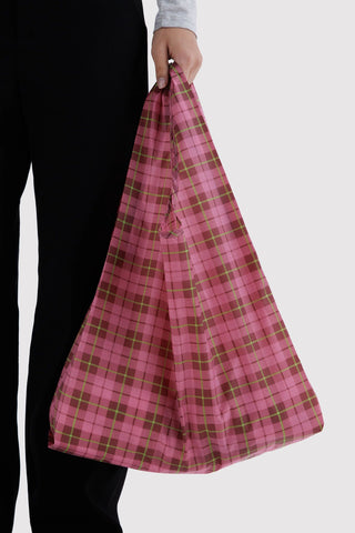 Pink plaid tote bag with wide open top, held by hand