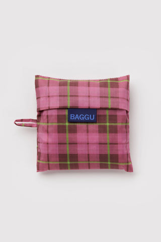 Folded pink tartan plaid tote pouch with BAGGU logo label