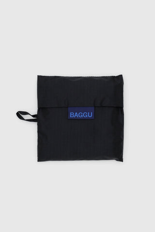 Foldable black BAGGU tote bag with strap and blue logo label