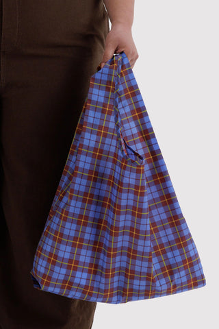 BAGGU blue tartan tote bag held by straps, check plaid fabric