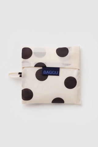 BAGGU compact bag pouch with black polka dots on cream, blue logo patch