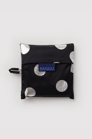 Folded black BAGGU tote bag with silver polka dots and logo patch