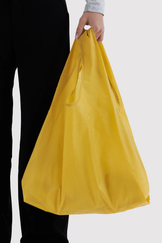 Sunflower-yellow BAGGU tote bag, large reusable shopping bag held open