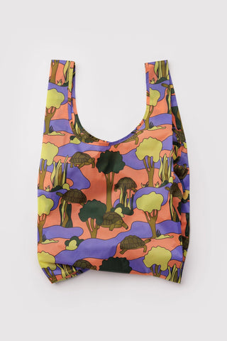 Reusable bag with colorful turtle and trees pattern on a white background