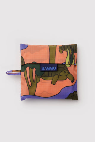 Folded reusable bag with colorful design and 'BAGGU' branding on a white background