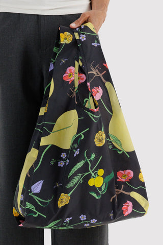 Standard tote bag with black base and yellow-green botanical floral print