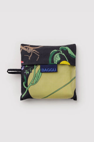 Packable tote pouch, black with yellow-green botanical print, blue BAGGU label