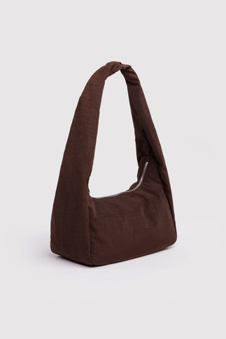 Brown shoulder bag on a light gray background