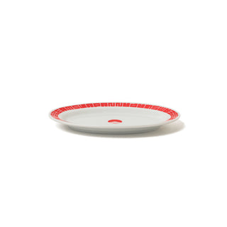 White plate with red decorative rim on a white background
