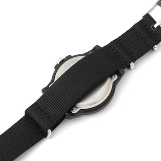 Close-up of a watch with a black strap on a white background