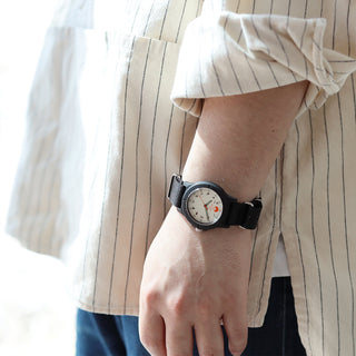 Person wearing a watch with a striped shirt
