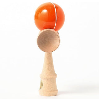 Kendama with orange ball and wooden handle on a white background