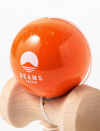 Orange ball with 'Beams Japan' logo on a wooden handle against a white background
