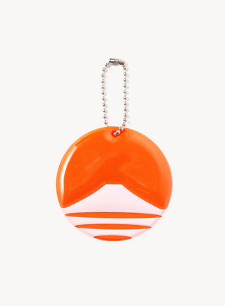 Round keychain with orange and white mountain logo on a white background