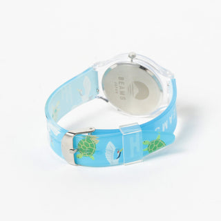Watch with a blue strap featuring green turtle designs on a white background