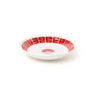 White dish with red decorative rim on a white background