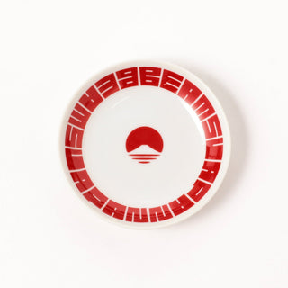 White plate with red decorative border the beams mountain logo on a white background