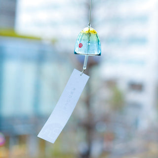 Decorative wind chime with a blurred outdoor background
