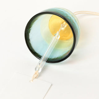 Close up of inside of a wind chime on a white background