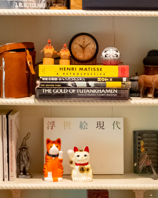 Bookshelf with books, decorative items, and a clock.