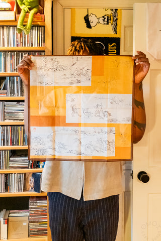 Person holding a handkerchief in front of a bookshelf